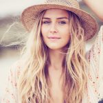 Portrait of a beautiful young girl in a hat. Warm vintage fashio